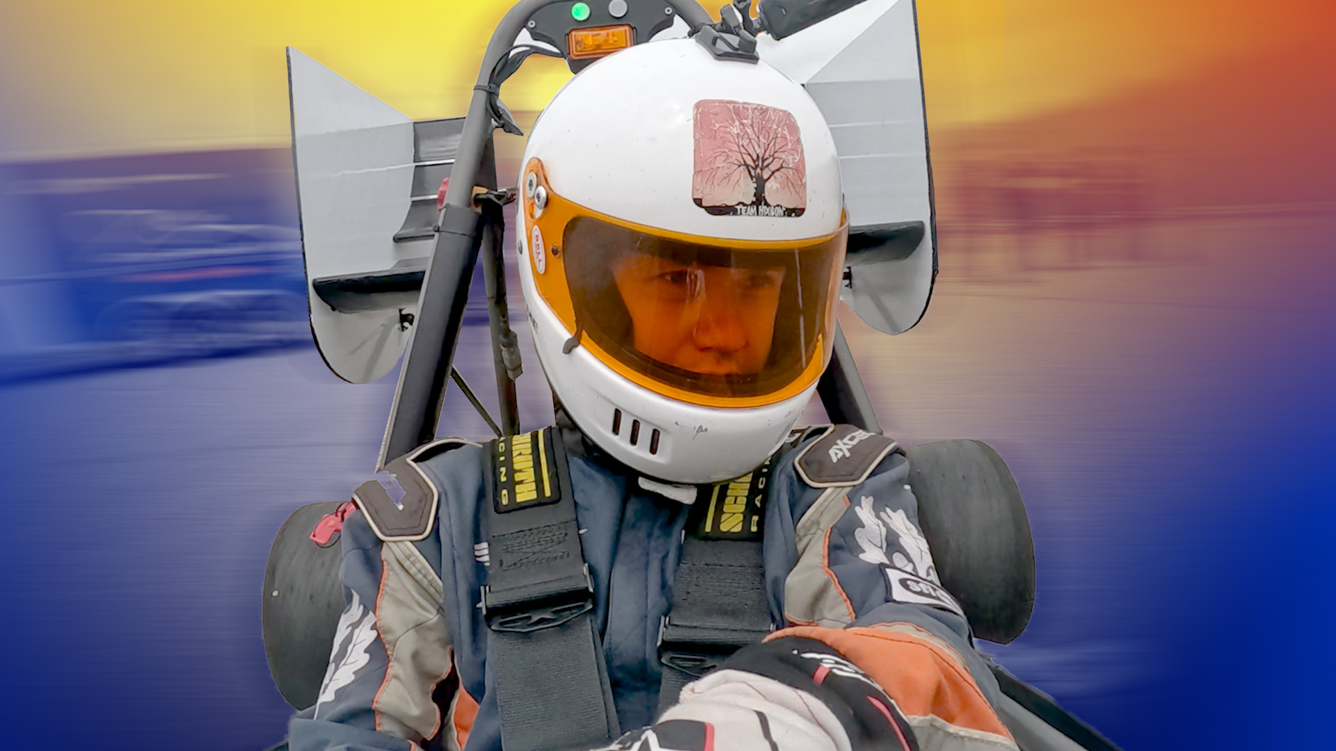 man in a F1 racing car with a colorful background